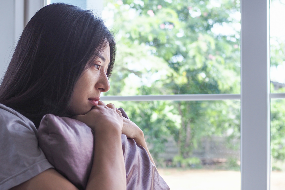 Woman Hugging a Pillow